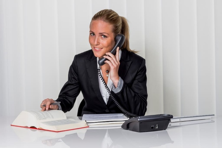 Lawyer Smiling While Calling Her Client